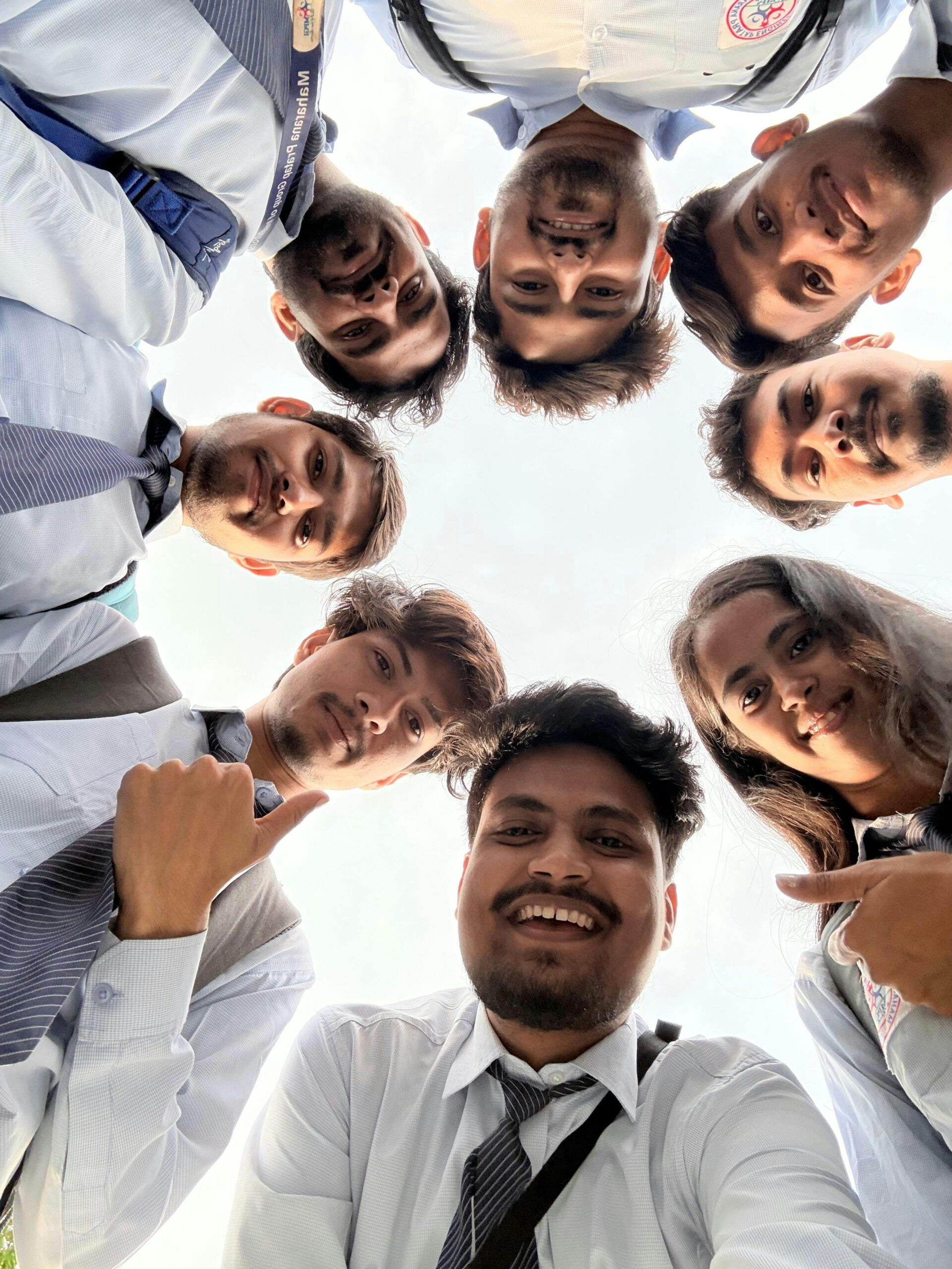 A joyful group of South Asian students in Kanpur, India, captured from below.